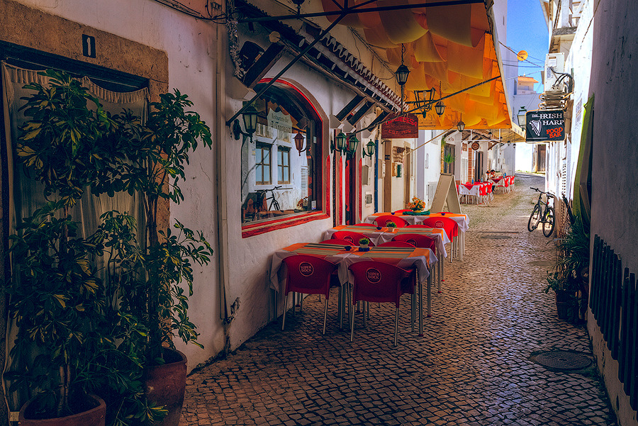 Sidewalk cafe with red chairs