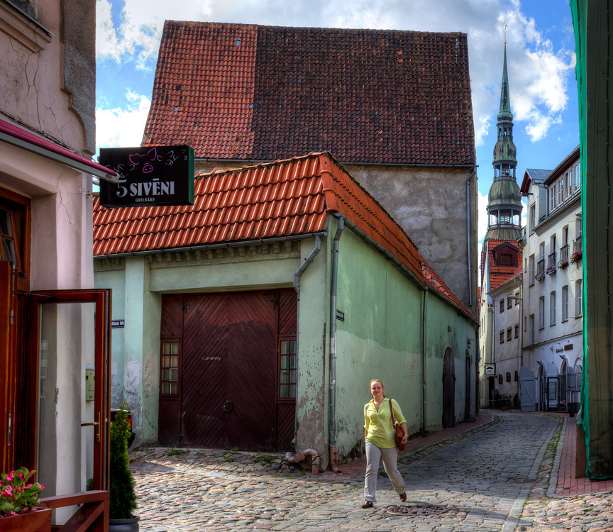 Tourist walks along the stoneblock pavement